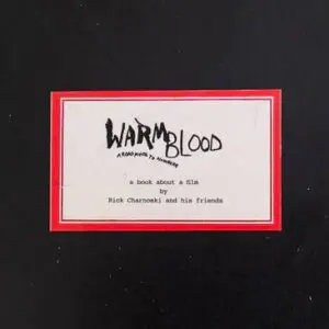 A red-bordered label with the text 'Warmblood' in black handwriting on a white background.