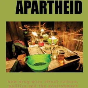 A table setting with lit candles and drinks under the word 'APARTHEID'.